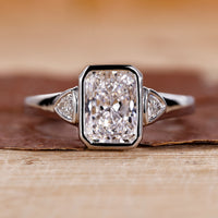 Radiant cut engagement ring with white gold ring.