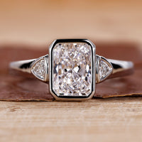 Radiant cut engagement ring with white gold ring.