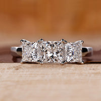 Princess cut diamond ring set in a classic white gold band.