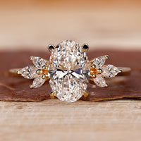 Hidden halo engagement ring with oval cut diamond in a claw prong setting yellow gold ring.