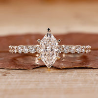 Hidden halo engagement ring with Dutch marquise ring.