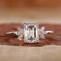 Emerald cut diamond ring with four claw prong setting.