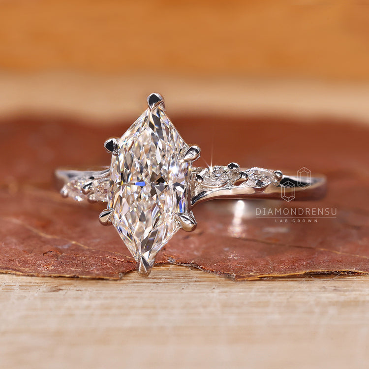Pave setting ring with marquise and round side stone.