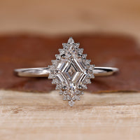 Halo diamond engagement ring with lozenge diamond engagement ring.