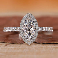 Halo diamond ring with round cut center stone.