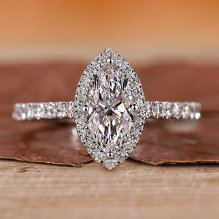 Halo diamond ring with round cut center stone.