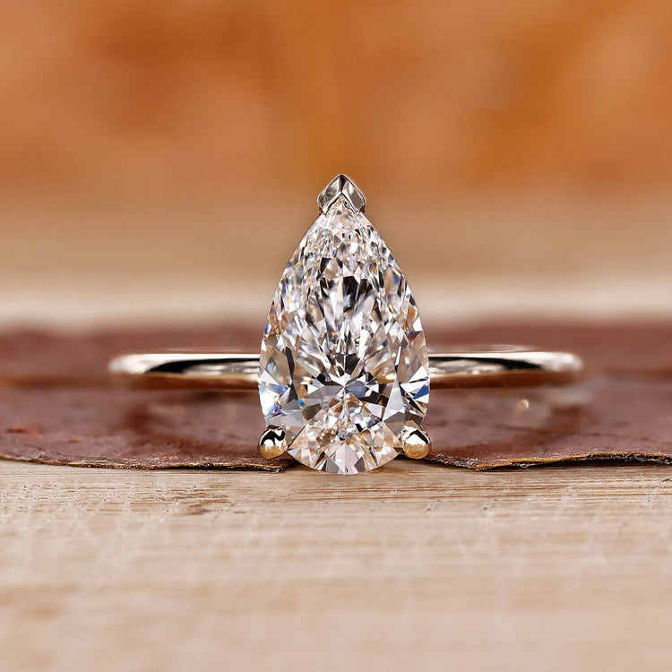 Pear diamond ring with v prong setting.