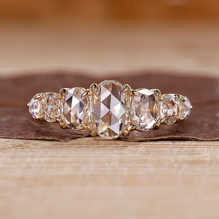 Hidden halo engagement ring with pear diamond.