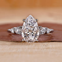 5 stone diamond ring featuring pear and round diamonds in white gold.