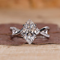 Marquise diamond ring with twisted pavé band in white gold.