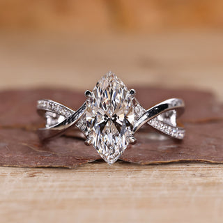Marquise diamond ring with twisted pavé band in white gold.