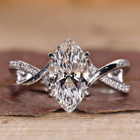 Marquise diamond ring with twisted pavé band in white gold.