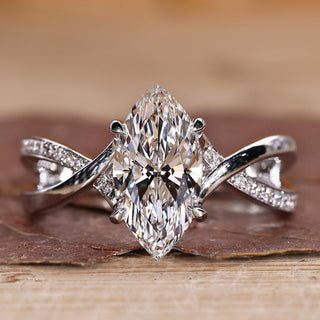 Marquise diamond ring with twisted pavé band in white gold.