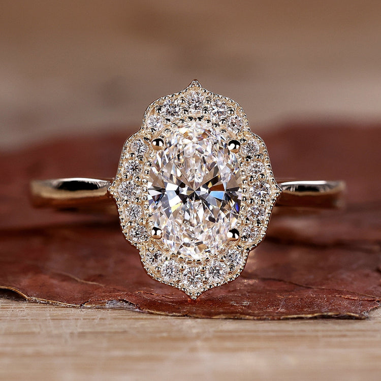 Close-up of a sparkling oval halo engagement ring with a polished silver band