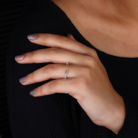 Prong setting in emerald and round cut wedding band.