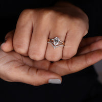 Pear shaped engagement ring set with lab grown diamond wedding bands.