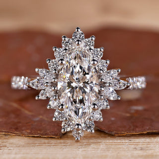 White gold engagement ring with marquise diamond and round halo.