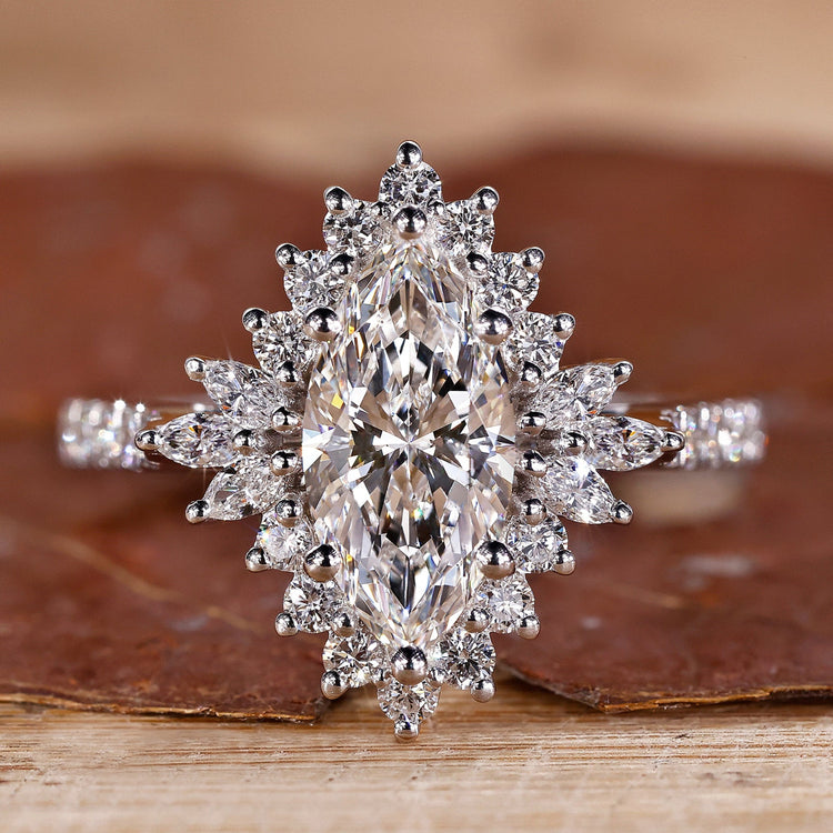 White gold engagement ring with marquise diamond and round halo.