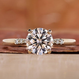 round engagement ring with yellow gold ring band.