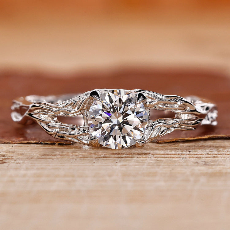 Nature inspired engagement ring with round diamond center.
