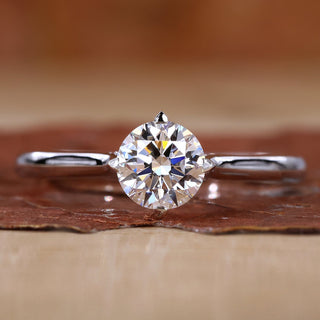 Close-up of round solitaire diamond ring with compass prongs setting