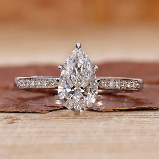 pear cut engagement ring with tapered pave band.