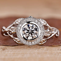 Bezel setting ring with round diamond and milgrain details.