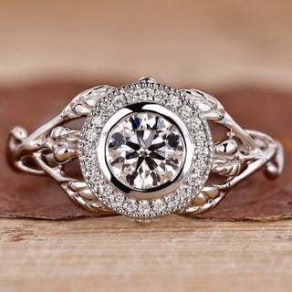 Bezel setting ring with round diamond and milgrain details.