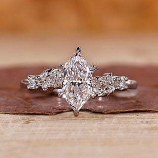 White gold engagement ring with Dutch marquise diamond and round side stones.