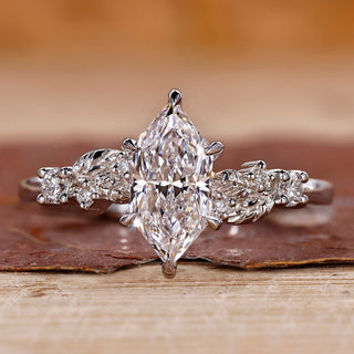 White gold engagement ring with Dutch marquise diamond and round side stones.
