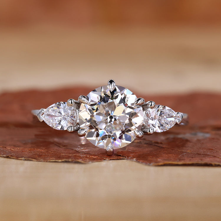 3 stone diamond ring with white gold band and classic setting in natural lighting.