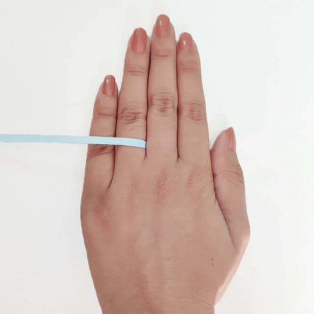 Wrap it around the base of your finger—not too tight or loose. Wrap it around the base of your finger—not too tight or loose.