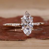 Close-up of a marquise cut diamond ring with a v prong setting, featuring lab grown diamonds.