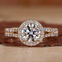 Halo diamond engagement ring in yellow gold with pavé detailing.