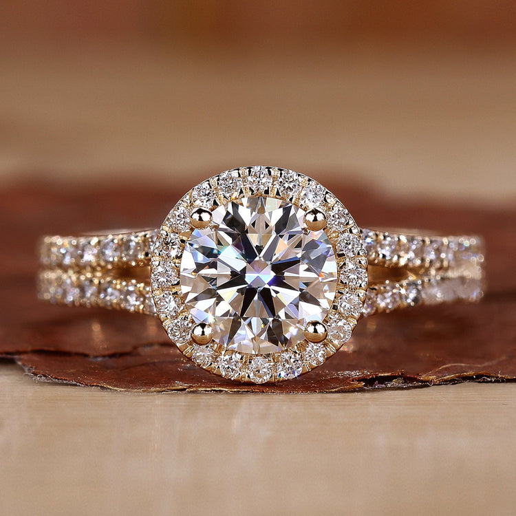 Halo diamond engagement ring in yellow gold with pavé detailing.