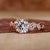 Nature-inspired engagement ring with a round brilliant cut diamond, featuring a tulip setting and claw prongs. Nature-inspired engagement ring with a round brilliant cut diamond, featuring a tulip setting and claw prongs.