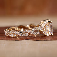 Hidden halo engagement ring with twisted pave band.