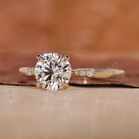 round cut stones in yellow gold ring setting.