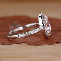 Halo engagement ring set in 4 claw prong setting.