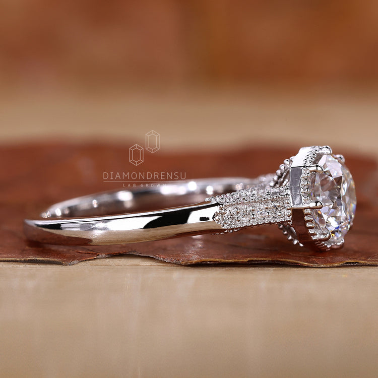 round cut side stones in handmade jewelry setting.