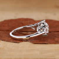 White gold ring with smooth polish and central diamond in a structured setting.