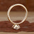 Side view of a marquise diamond ring featuring claw prongs and a yellow gold setting.