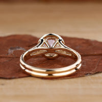 Cathedral setting engagement ring with round centre diamond.