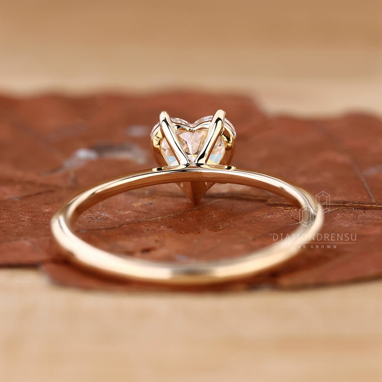 Yellow gold diamond ring with heart shaped centre.