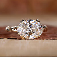 East West engagement ring with oval diamond.