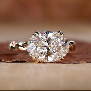 East West engagement ring with oval diamond.