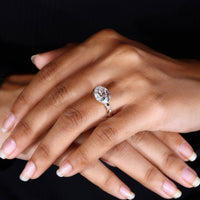 Hidden halo ring with double claw prong setting.