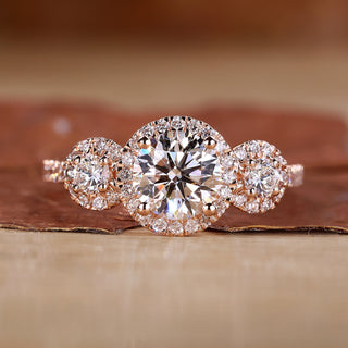 3 stone engagement ring with round cut diamonds in rose gold.