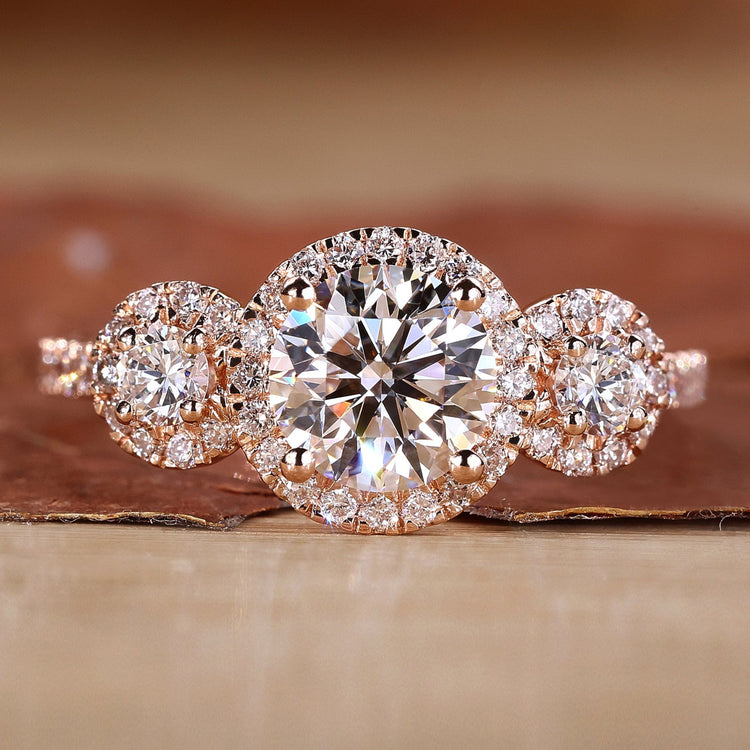 3 stone engagement ring with round cut diamonds in rose gold.