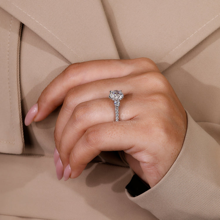 Pavé ring setting with three diamonds and claw prong design.
